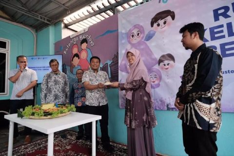 Camat Cilodong, Zaenal Arifin memberikan potongan tumpeng kepada Branch Manager Rumah Zakat Depok, Novita Maharani.